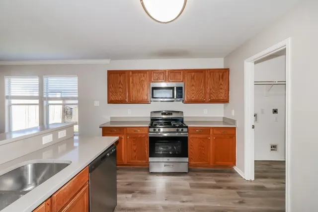 a kitchen with stainless steel appliances granite countertop a sink stove and refrigerator