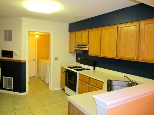 36166 North Edgewater Court Gurnee, IL 60031 - Photo 6 of 12 a kitchen that has a sink and a stove