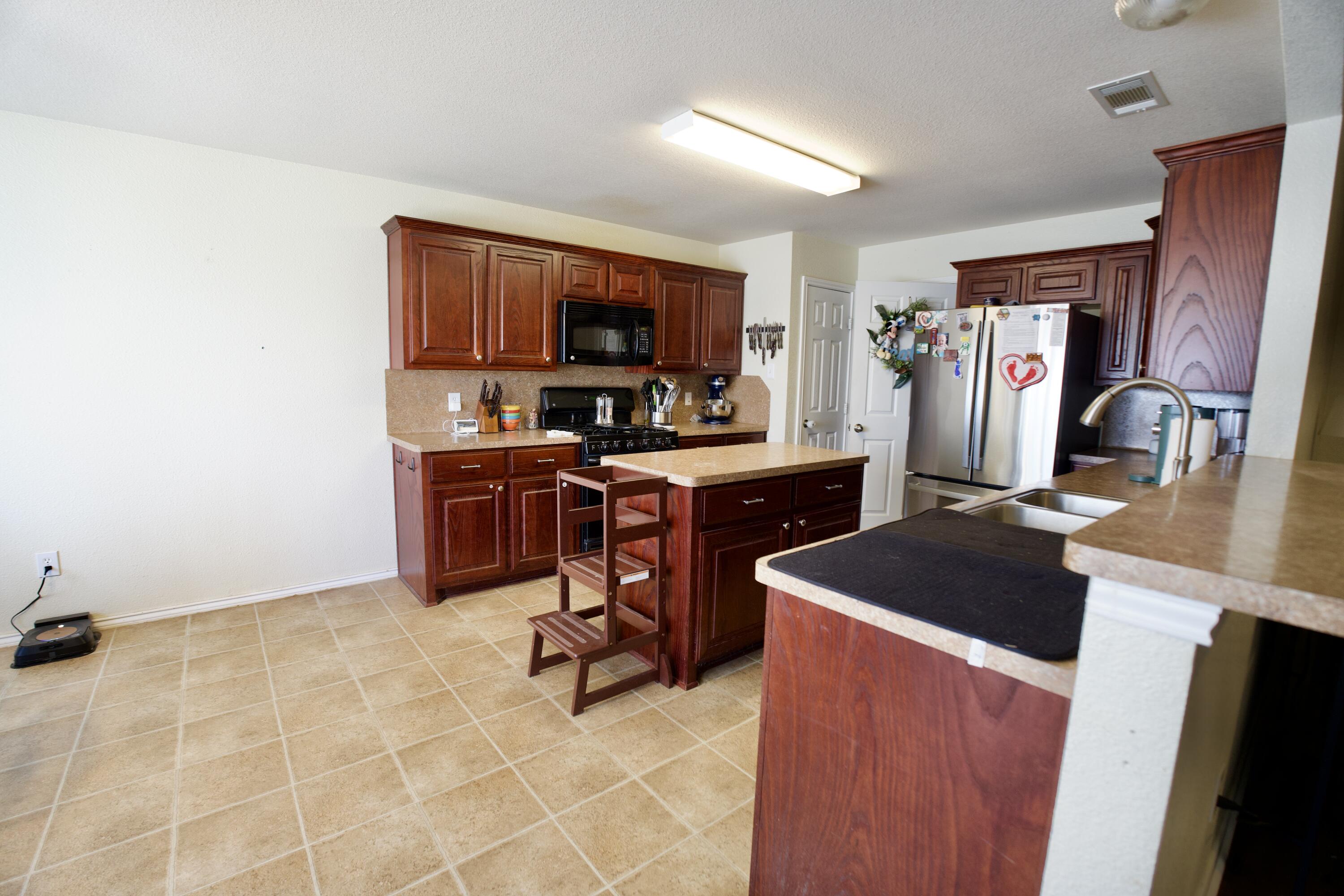 8811 16th Street Lubbock, TX 79416 - Photo 11 of 17 a view of kitchen with stainless steel appliances granite countertop sink stove top oven and cabinets