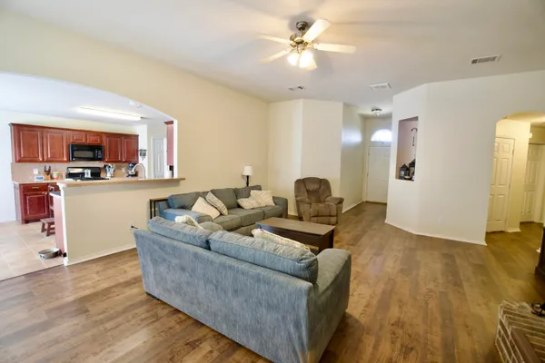 a living room with furniture and a wooden floor