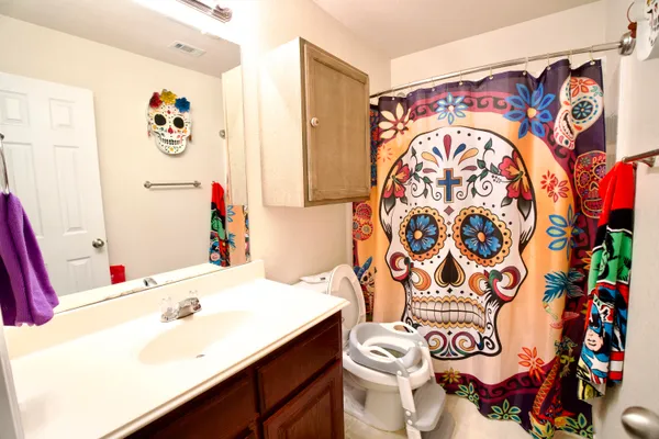 a bathroom with a sink and mirror with toilet
