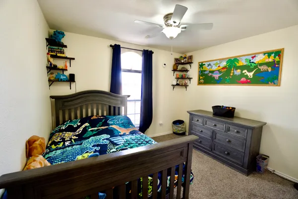 a bedroom with a bed table and a window