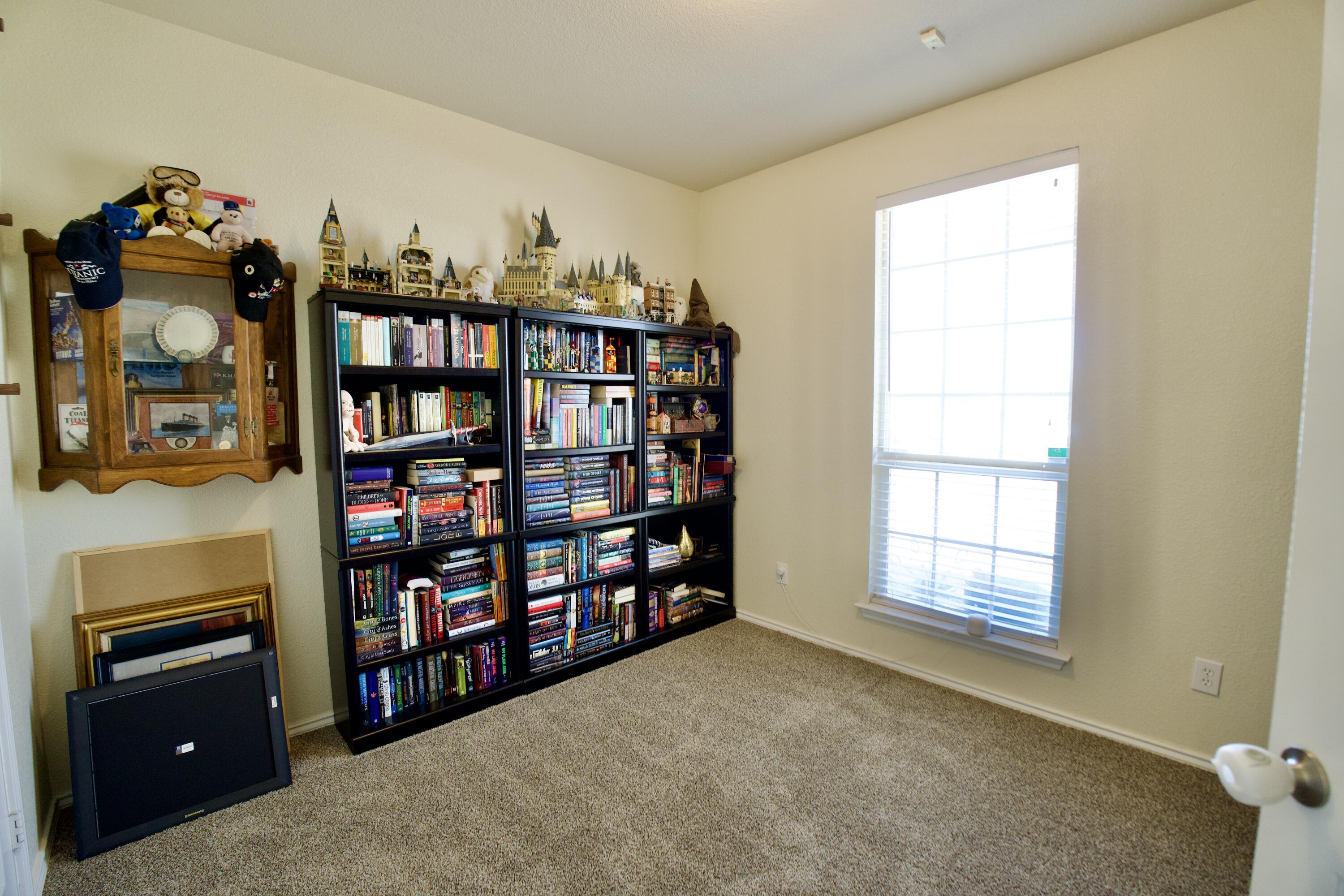 8811 16th Street Lubbock, TX 79416 - Photo 6 of 17 a room with bookshelf and a window