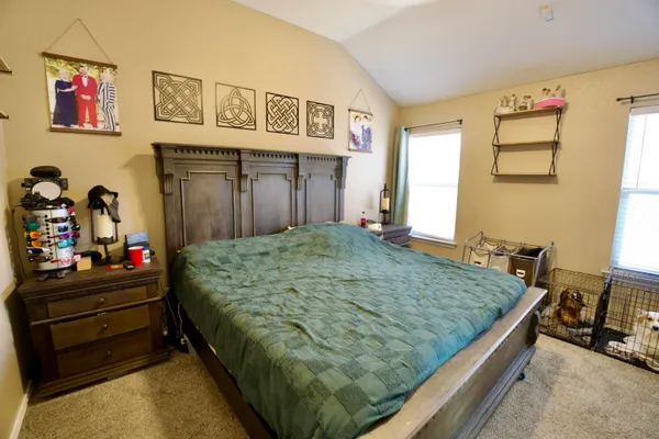 a bed sitting in a bedroom next to a window