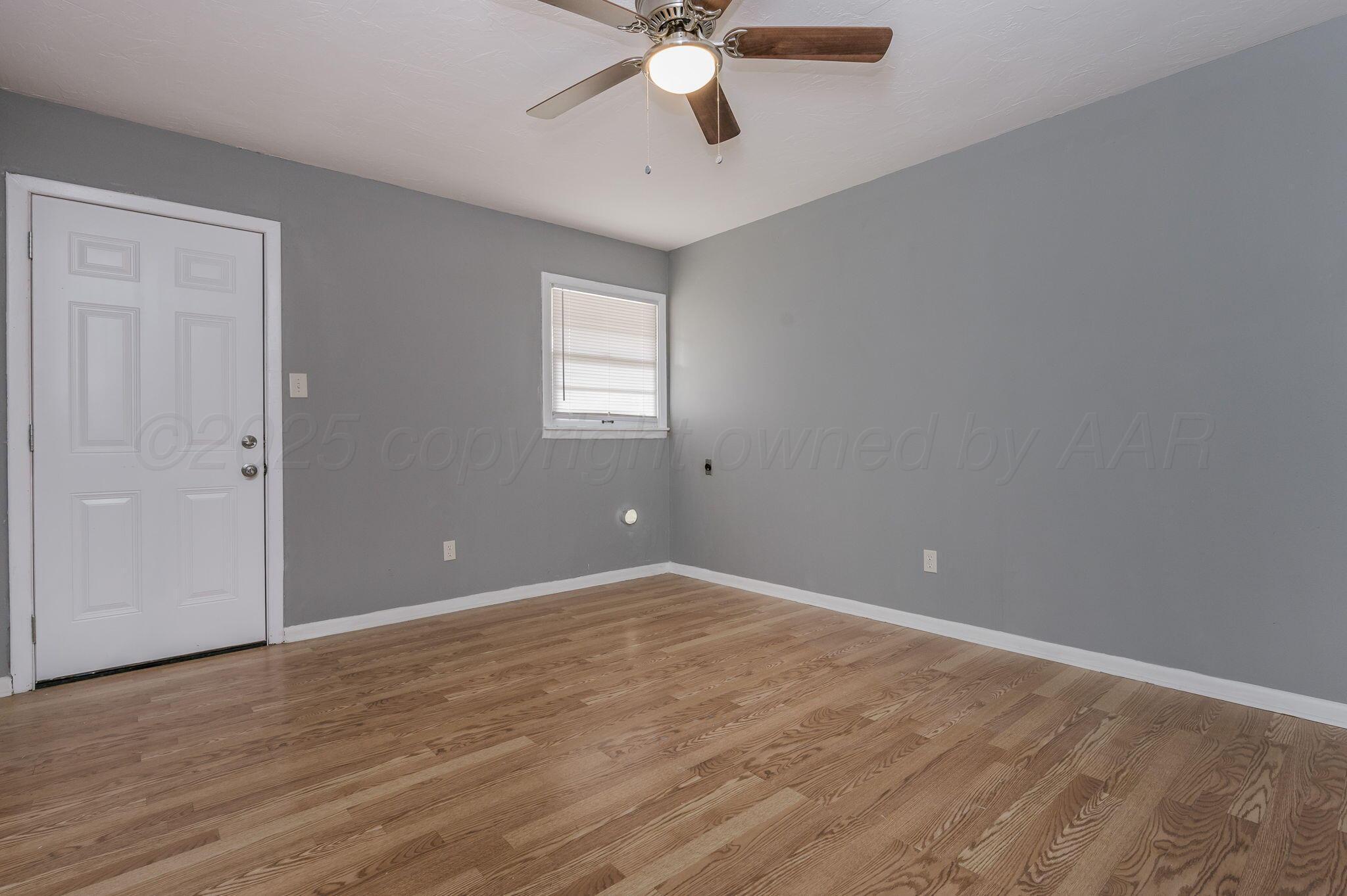 609 16th Street, Unit 3 Canyon, TX 79015 - Photo 11 of 15 a view of an empty room with window and wooden floor