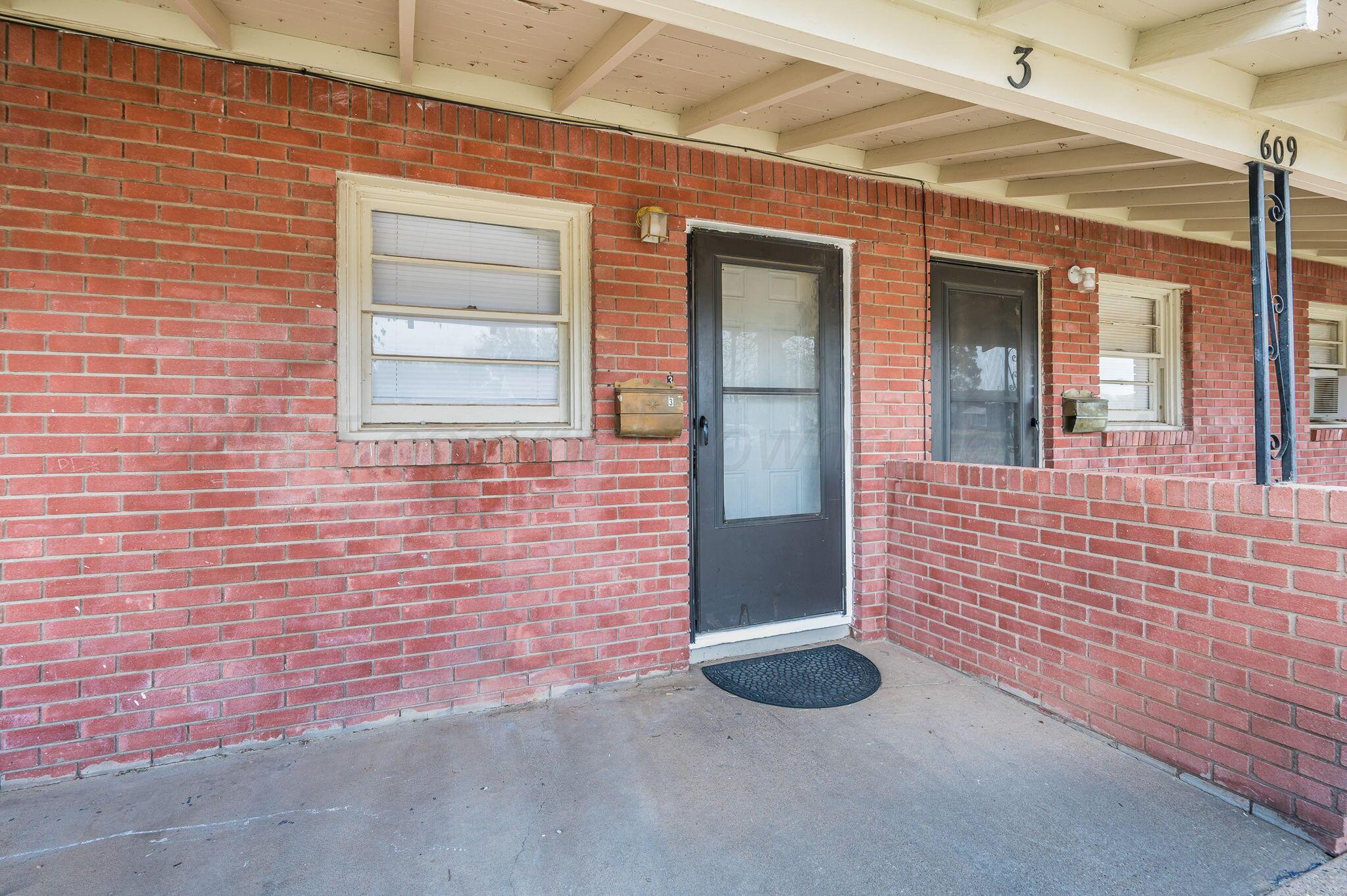609 16th Street, Unit 3 Canyon, TX 79015 - Photo 2 of 15 a view of a brick house with a large window