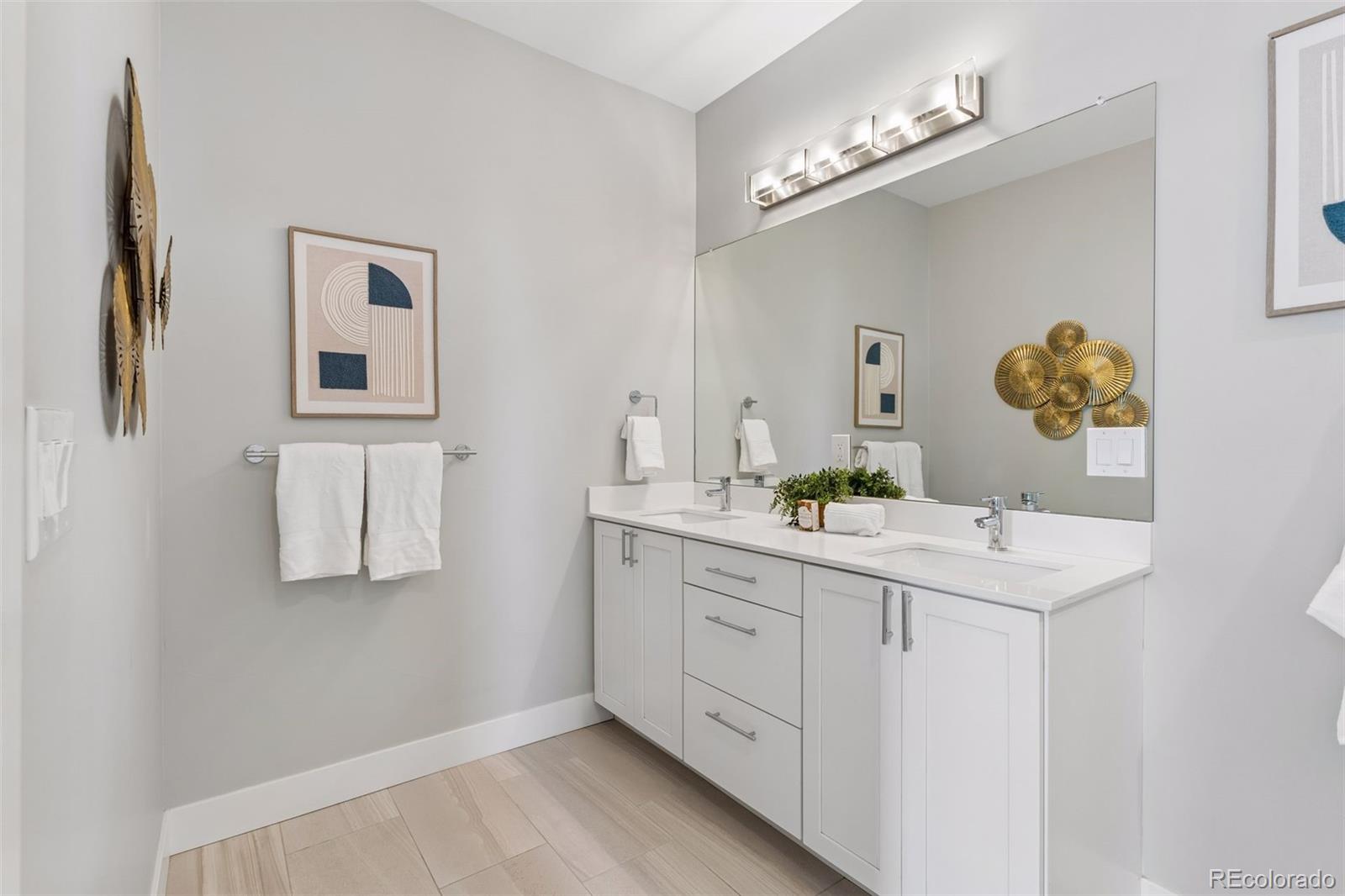 1235 Perry Street Denver, CO 80204 - Photo 21 of 41 a bathroom with a sink a vanity and a mirror