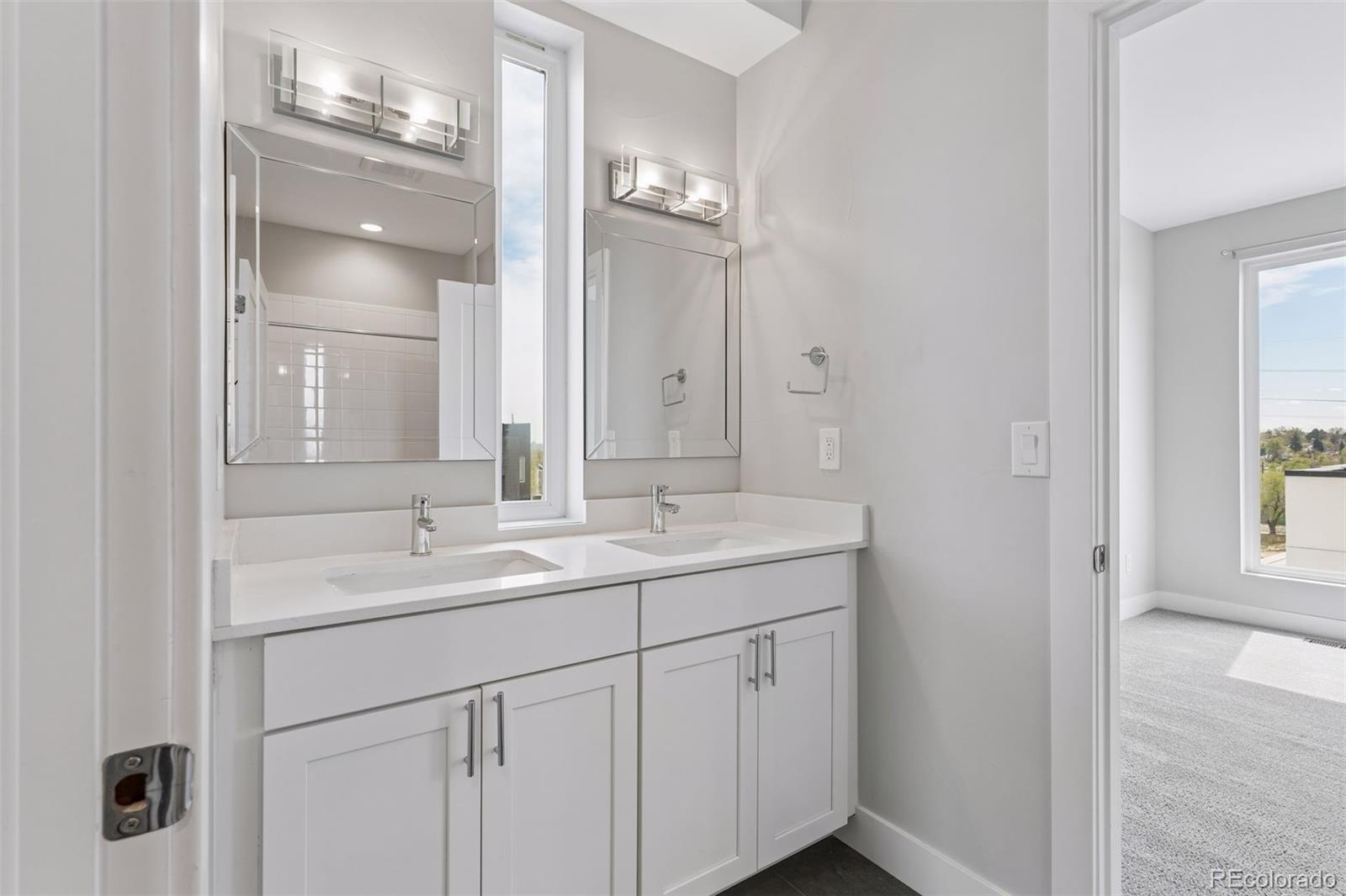 1235 Perry Street Denver, CO 80204 - Photo 27 of 41 a bathroom with a double vanity sink and mirror with window