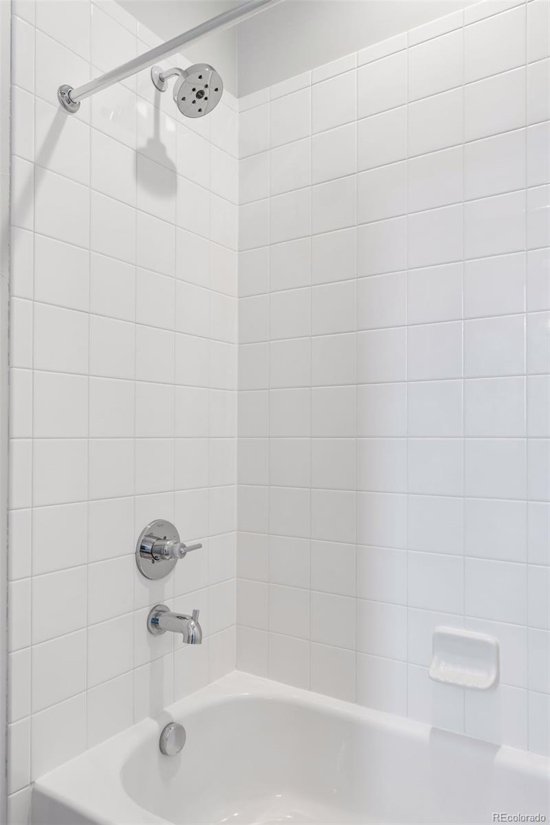 1235 Perry Street Denver, CO 80204 - Photo 28 of 41 a bathroom with a shower and a bath tub