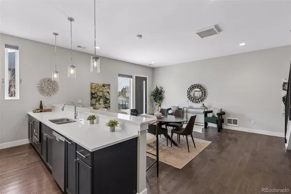 a kitchen with a dining table chairs sink and cabinets