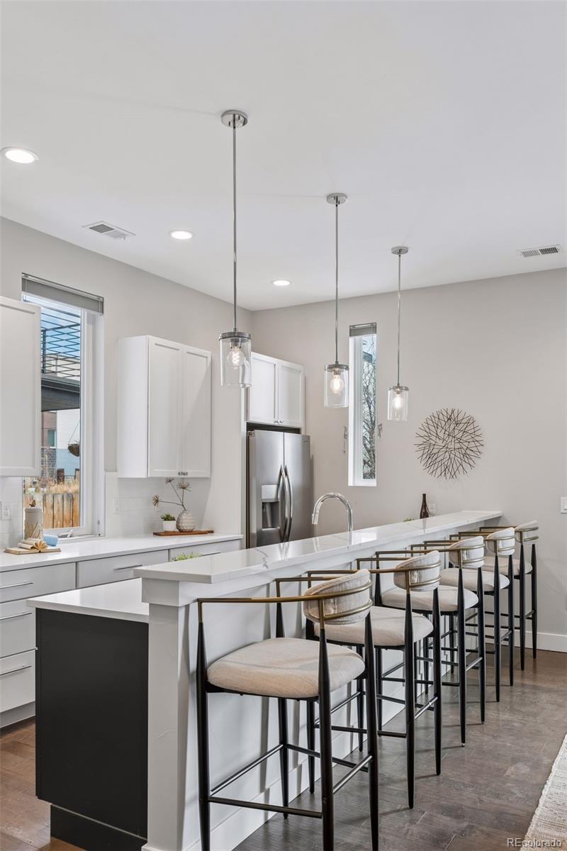 1235 Perry Street Denver, CO 80204 - Photo 9 of 41 a kitchen with a dining table chairs sink and cabinets