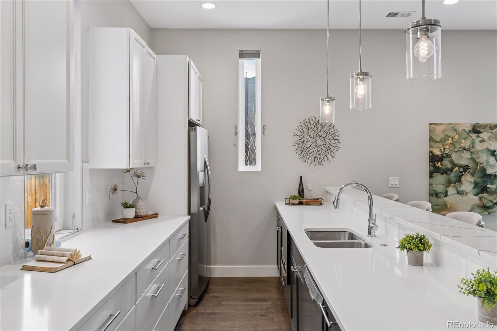 1235 Perry Street Denver, CO 80204 - Photo 10 of 41 a kitchen with stainless steel appliances a sink a stove and a refrigerator