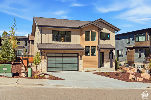 4092 Discovery Way Park City, UT 84098 - Photo 2 of 66 Modern architectural style featuring a multi-tone exterior, stone accents, and a contemporary glass panel garage door