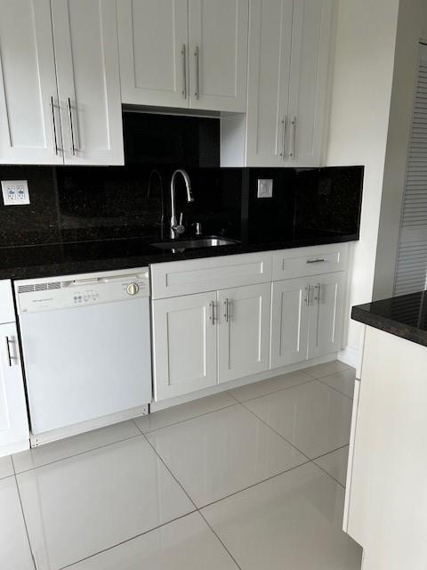 3590 Blue Lake Drive, Unit 305 Pompano Beach, FL 33064 - Photo 13 of 23 a close view of a stove a microwave and cabinets