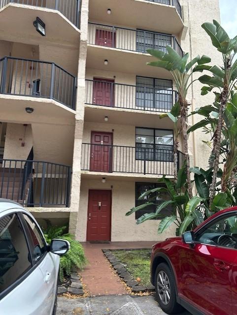 3590 Blue Lake Drive, Unit 305 Pompano Beach, FL 33064 - Photo 2 of 23 a front view of a house with a yard