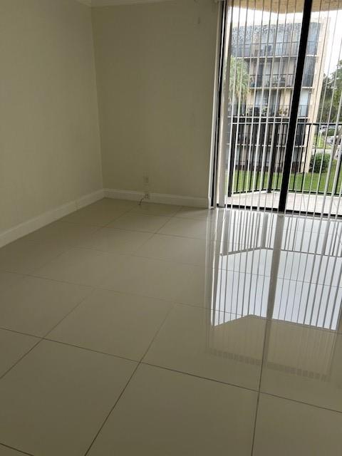 3590 Blue Lake Drive, Unit 305 Pompano Beach, FL 33064 - Photo 21 of 23 a view of wooden floor and a window