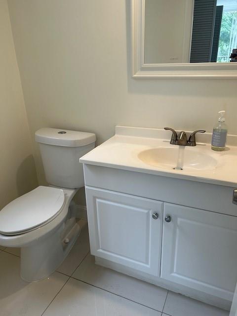 3590 Blue Lake Drive, Unit 305 Pompano Beach, FL 33064 - Photo 6 of 23 a bathroom with a toilet sink and mirror