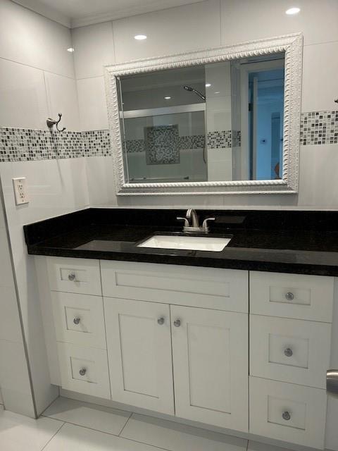 3590 Blue Lake Drive, Unit 305 Pompano Beach, FL 33064 - Photo 8 of 23 a bathroom with a sink and a mirror