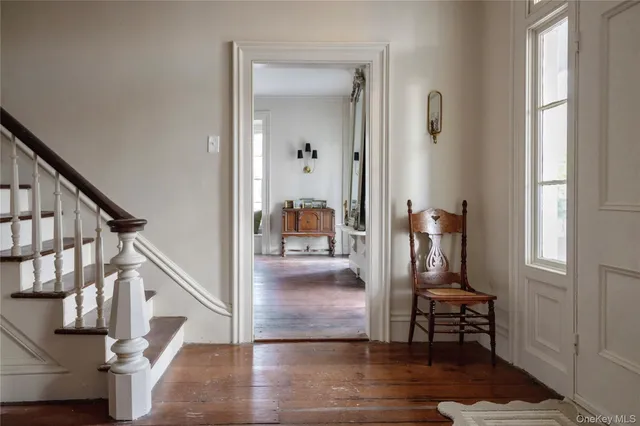 a view of entryway and hall with wooden floor