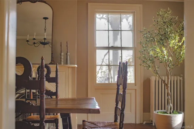 a view of a hallway with wooden floor and windows