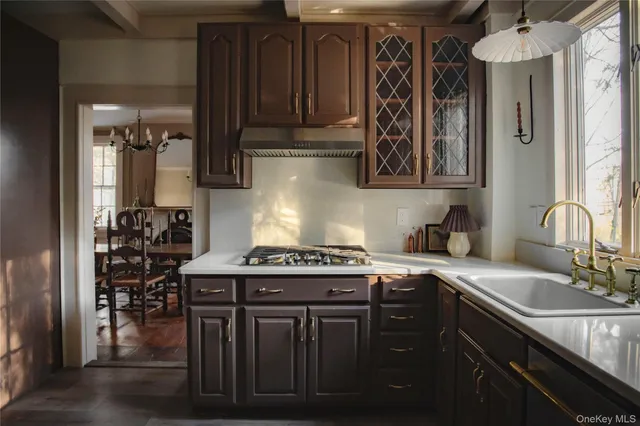 a kitchen with stainless steel appliances granite countertop a sink stove and cabinets
