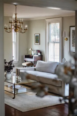 a living room with furniture and a chandelier