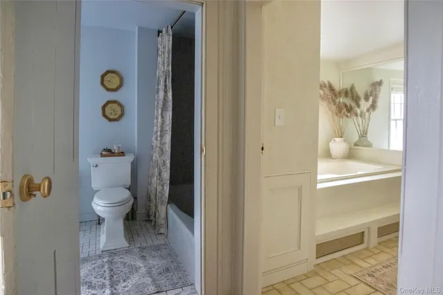 a bathroom with a toilet and a shower curtain