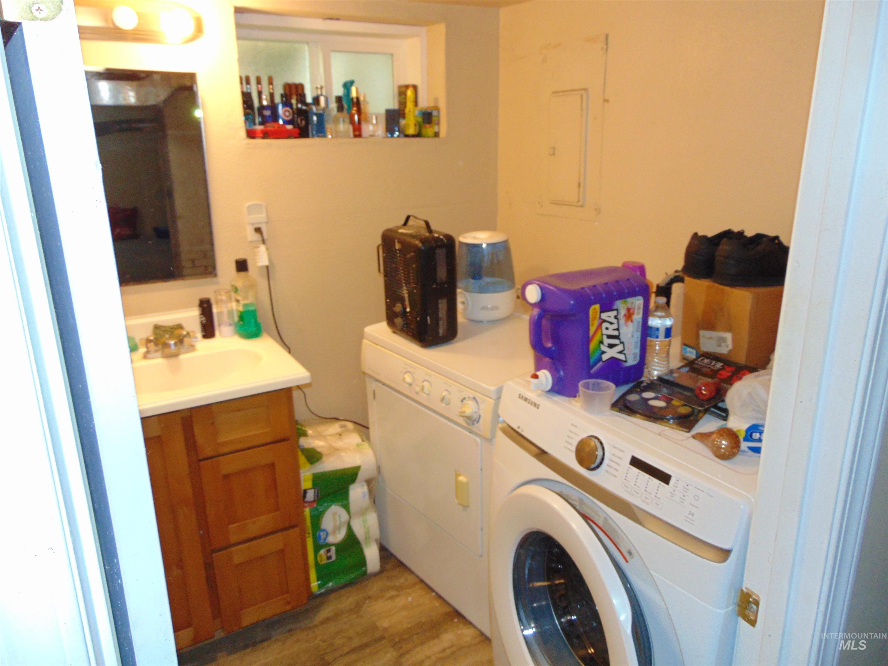 1437 Idaho Street Lewiston, ID 83501 - Photo 12 of 14 Laundry room featuring wood finished floors, electric panel, and washer and clothes dryer