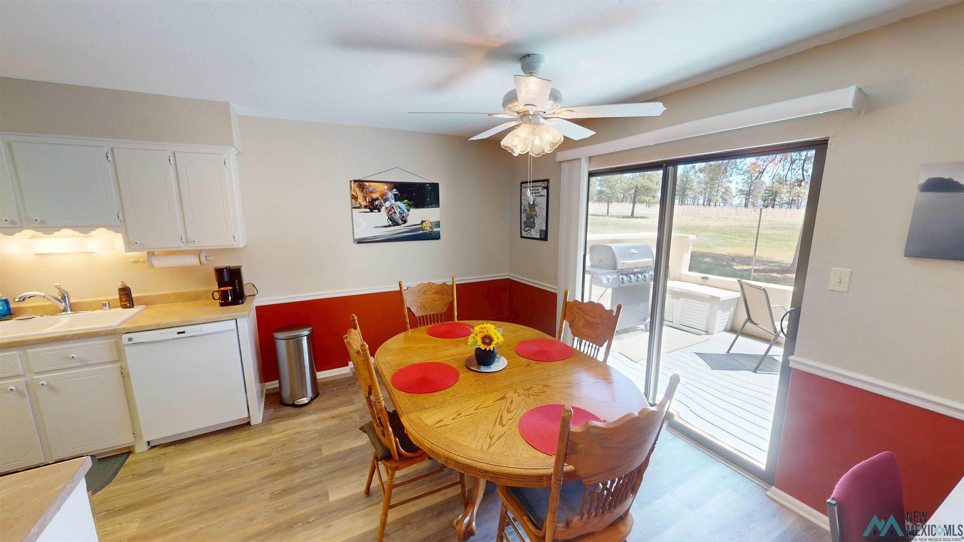23 Pendaries Lane Rociada, NM 87742 - Photo 5 of 26 Dining area featuring wood-finish flooring and a ceiling fan with integrated lighting