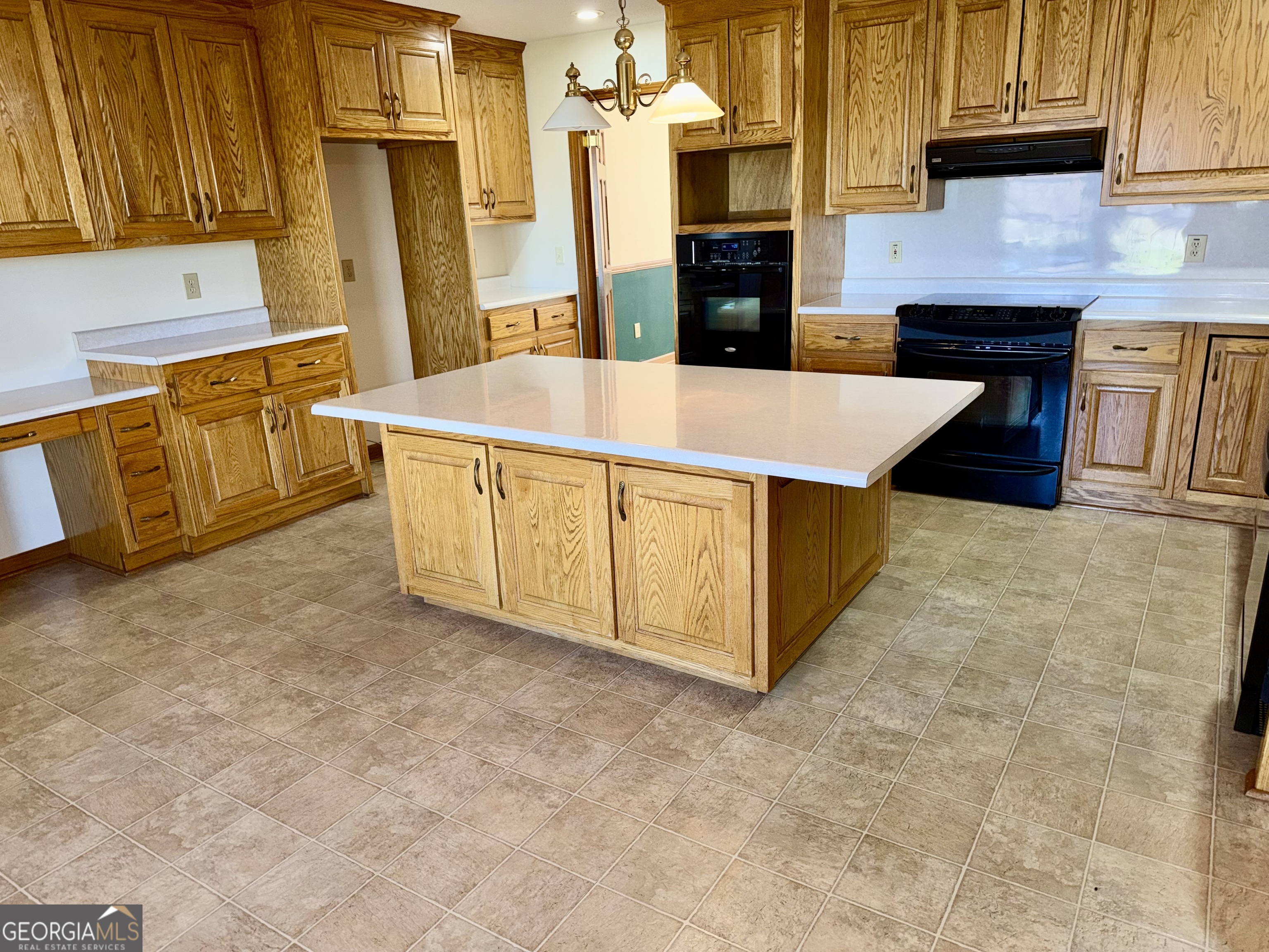 494 Broad Street Bowman, GA 30624 - Photo 24 of 65 a kitchen with stainless steel appliances wooden cabinets and a counter top space