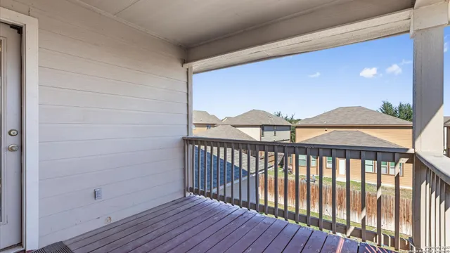 a view of a balcony with wooden floor