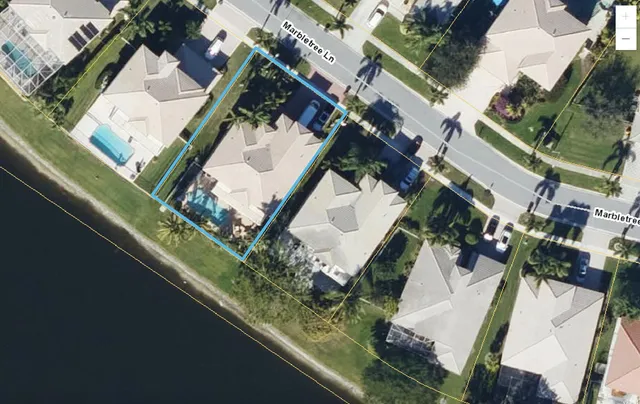 an aerial view of a house with a yard
