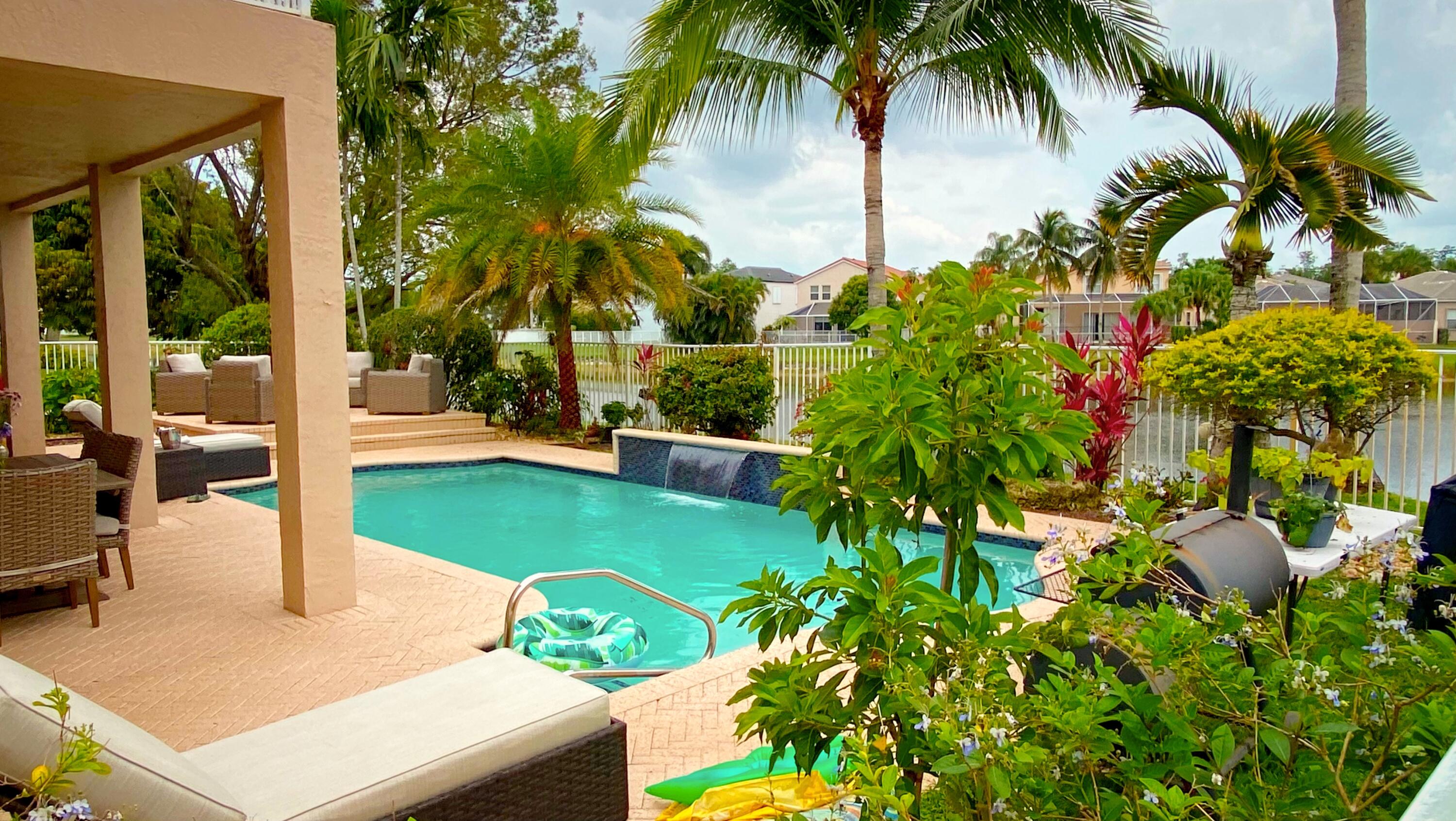 Undisclosed Address Lake Worth, FL 33467 - Photo 5 of 9 a view of a backyard and swimming pool