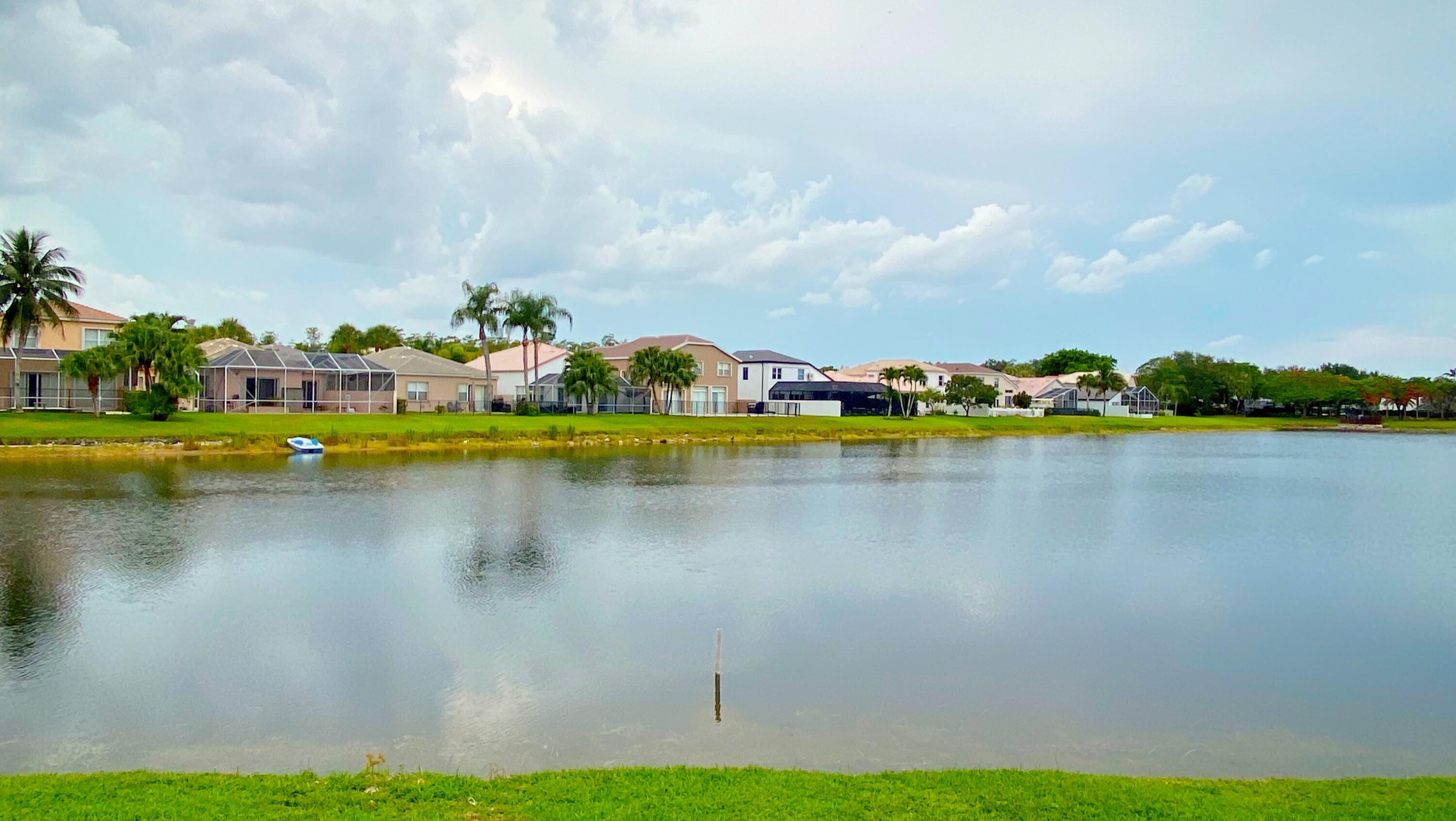 Undisclosed Address Lake Worth, FL 33467 - Photo 6 of 9 a view of a lake with houses in the back
