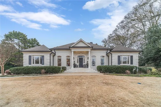 a front view of a house with garden