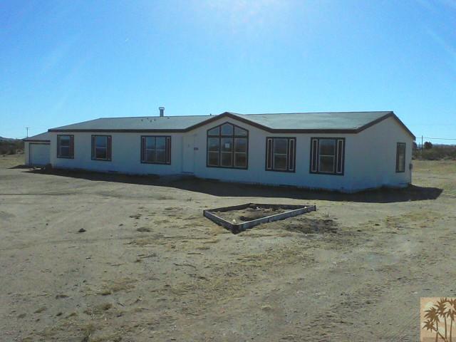 56579 Cubero Road Landers, CA 92285 - Photo 1 of 13 a front view of a house with a yard
