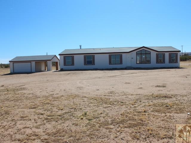 56579 Cubero Road Landers, CA 92285 - Photo 12 of 13 a front view of a house with a yard