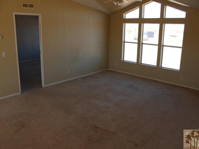 56579 Cubero Road Landers, CA 92285 - Photo 3 of 13 an empty room with a empty space and windows