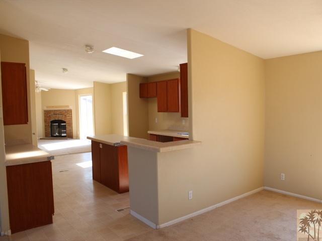 56579 Cubero Road Landers, CA 92285 - Photo 5 of 13 a kitchen with stainless steel appliances wooden cabinets and a sink