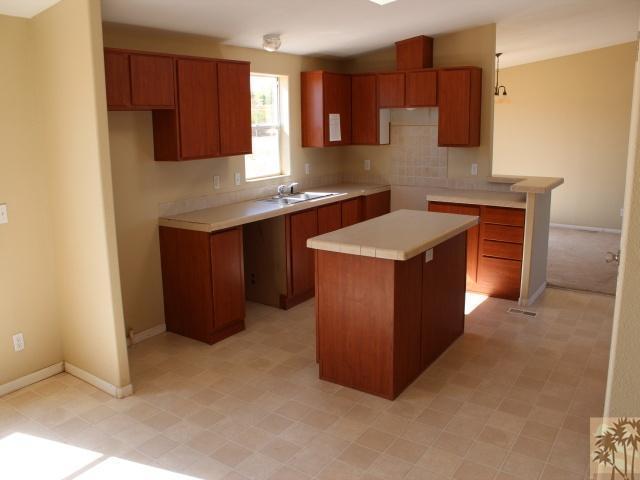 56579 Cubero Road Landers, CA 92285 - Photo 6 of 13 a kitchen with stainless steel appliances granite countertop a stove a sink and a refrigerator