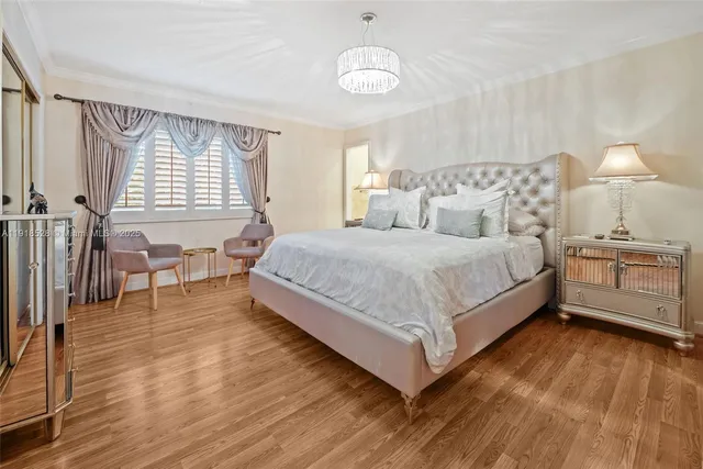 a bedroom with a bed and a table chair