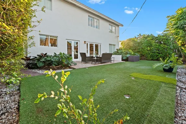 a front view of house with yard and outdoor seating