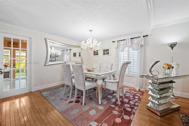 a dining room with wooden floor and breakfast area