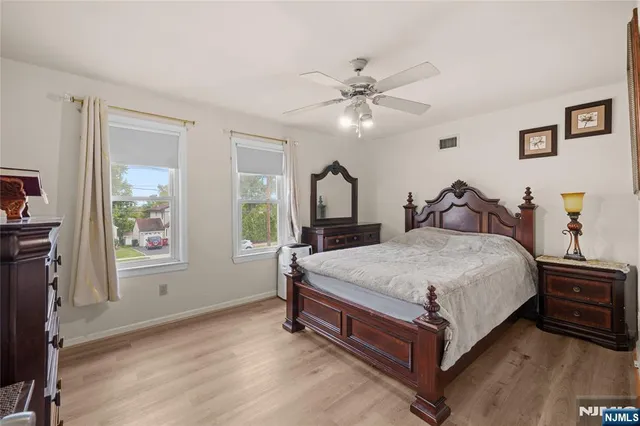 a bedroom with a large bed and a chandelier