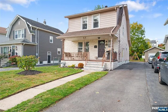 a front view of a house with a yard and porch
