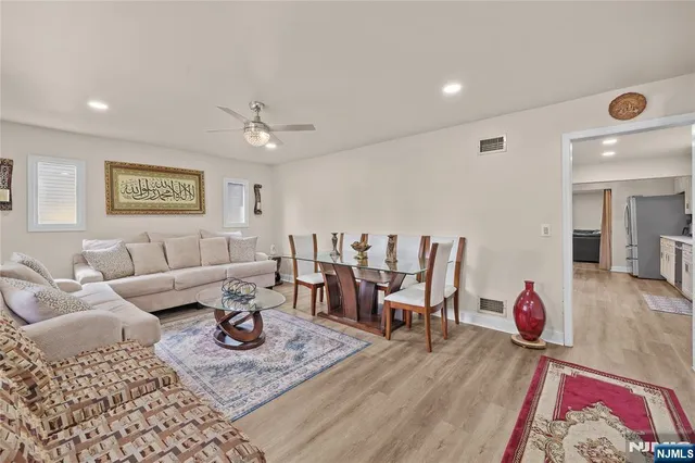 a living room with furniture a rug and a table