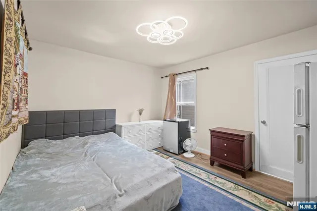 a bedroom with a bed and a chandelier