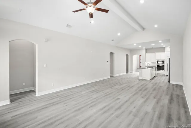 a view of a kitchen with a sink and a refrigerator