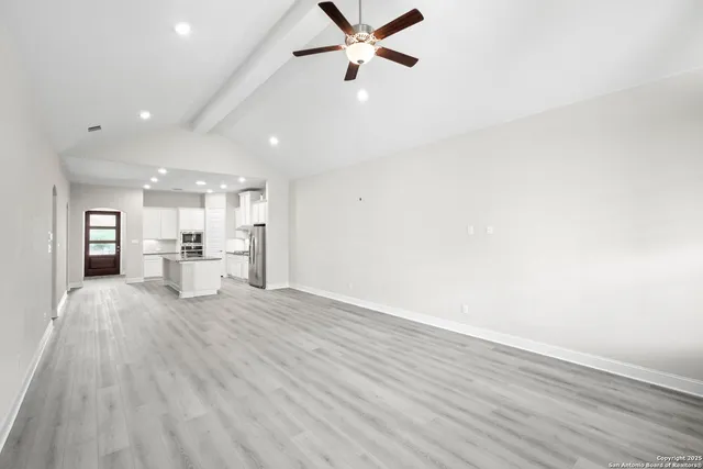 a view of a livingroom with a hardwood floor and a ceiling fan
