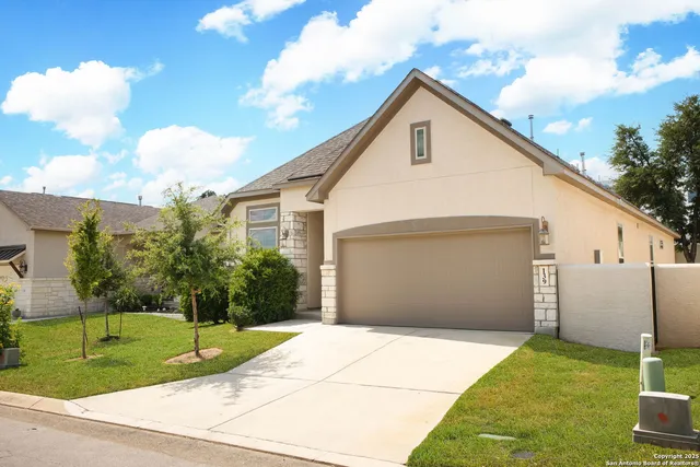 a view of backyard of house and trees